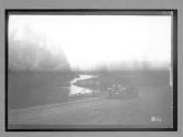[auto driving by river]