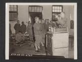 [A new type of generator for fire unit of a field range is being shown by Capt James E. Pevey of the office of Chief Quartermaster, to cooks and mess Sergeants]