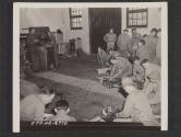 [Cooks and mess sergeants of an infantry division dissasembling the fire units of their field ranges at a school held to acquaint them with field range problems that might arise under field conditions.]