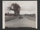 [M8 Armoured scout car traveling along a highway while on tactical exercises somewhere in England.]