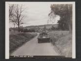 [Sgt. William Curtis, Cynthiana, KY., Commander of a M8 Armored Scout Car looks the country over before proceeding on tactical excerises somewhere in England]