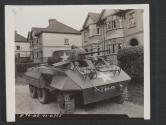 [An M8 armored scout car stands on guard at a road junction during a tactical excerise in Engalnd.]