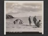 [American soldiers on maneuvers wash their mess kits in the English Channel after noon-day mess. France doesn't seem very far away on this day.  7th Engr Regt, 5th Inf Div. Blackpool Sands, Devon, England.]