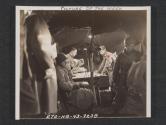 [In the command post tent during firing practice on a range in the United Kingdom are computers, fire direction officers, and H.C.A. and V.C.O. 21st FA BN, 5th Inf Div., near Annalong, County Down, No. Ireland.]