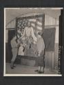 [PVT Julian Rusnak, Chicago, ILL., putting the finishing touches on a large altar painting he painted for a division chapel as chaplain Harold Prudell, Milwaukee. WIS., looks on. 5th Inf Div, Tollymore Park Camp, Bryansford, No. Ireland.]