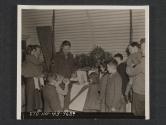 [M/Sgt William K. Hall, Detroit, MICH., left, and Cpl David Karolins distribute x-mas gifts to Irish children.  5th Inf Div, Tollymore Park, Bryansford, No. Ireland.]