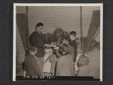 [Chaplain Herman Dickes, Brooklyn, N.Y., plays Santa Claus to some Irish children. The gifts were given by American soldiers. 5th Inf Div, Tollymore Park Camp, Bryansford, No. Ireland.]