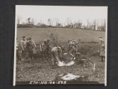 [Gas school in Northern Ireland. A decontamination squad making a mixture of chloride of lime, dirt and water to be used by them to step in to decontaminate their shoes before returning to decontaminate a shell hole. 5th Inf Div, Seaforde, Co. Down. No. Ire.]