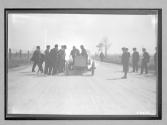 [auto racer talking to spectators]
