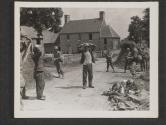 [Sgt. Justin Sharp, left, of Louisville, KY., and S/Sgt. Rogers Hunter, right, of St Louis, MO., both members of an infantry unit, cover the two German prisoners they captured, somewhere in France. St Ouen des Besaces, France.]