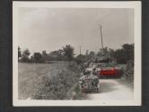 [A long line of jeeps pass a tank, as armored and mechanized units move up to the front, somewhere in France. St Ouen des Besaces, France.]