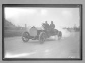 [auto racers reving engine at track]