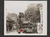 [Private Ivan Lewis, Chicago, Ill., gets a tomato from a French woman during a halt in the drive into Angers, France.]