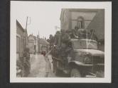 [Pfc. John Lannon, BKLYN, N.Y.,  recieves a bouquet from a French girl as a token of welcome and gratitude, while passing through the town of Chartres, France.]