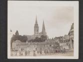 [American dough-boys enter the famous city of Chartres, France. In the back ground is the famous Chartes cathederal which dates back to the 12th century and is one of the most beautiful landmarks in France.]