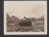 [An American tank leaves a stream after passing through enroute to Fountainbleau. American Engineers are repairing a bridge at the left of the tank to permit vehicular traffic to pass over the stream.]