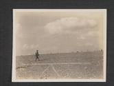 [Infantrymen, who still do the final hand to hand fighting even in these days of vast mechanized armies, cautiously advance over the open fields to Milly, France.]