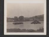[A section of a pontoon bridge is rowed out to be joined up with those already in place. The Bridge is being built by US Army Engineers to replace one destroyed during the action around the town of Vulaines-Sur-Seine, France.]