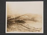 [An aerial photo of Fort Driont [sic], A German held fort opposite the town of Ars-Sur-Moselle, France, which is the main obstacle in the way of the 3rd Army's capture of Metz, France. This German Fort, which has been holding up the units of the 3rd Army for some time in this sector, is about 1/2 mile in length and is protected by pillboxes, moats and fortification with the capture of this Fort and the town on the opposite bank of the river the enemy at Metz can be attacked from another angle. The smoke at the left center is caused by the landing of a U.S. Artillery shell. Air Sec. 5th Inf. Div]