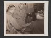 [General George C Marshall, chief of staff, US Army, discusses new moves during a visit to the headquarters of an infantry unit, somewhere in France. Before him is a relief map of the terraian under discussion. HQ 5th Inf Div., Preny, France.]