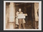 [Screen actress Marlene Dietrich leaves a hall in Arry, France, holding the cake with which she was presented by members of an Infantry unit. Miss Dietrich is touring the combat zones, entertaining the men on the fighting front.  11th Infantry Regt., 5th Inf Div.]