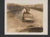 [Maj Gen John Millikin, commanding General of the 3d Corps, rided in a jeep at the flooded streets of Pont-A-Mousson, France. The jeep receives a tow as the flooded waters of the Mosele River (highest in thirty years) flow the main streets of the town.  Flood waters of Moselle River, 3d Corps Pont-A-Mousson, France.]