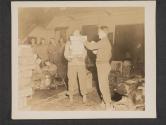[Tec. 5 Victor Tennison, Three Rivers, Mich., receives armful of Christmas packages and mail for the telephone and teletype section of a signal company near La Houve, France.]