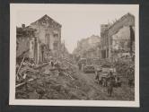 [Infantrymen of the 5th Division, 1st [3rd] U.S. Army, walk through streets in town of Bitburg, Germany, hard hit by air bombardment preceding their advance.  11th Regt 5th Inf Div FUSA [TUSA]]