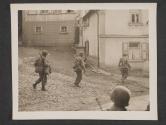 [Infantrymen of 3rd US Army pass a crucifix in Bockenau, Germany.  TUSA; Bockenau, Germany.]