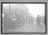 [racers and autos in town]