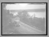 [auto tour parked on road by water]