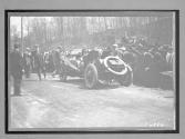 [auto racers in front of spectators]
