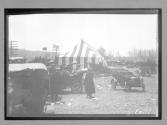 [autos parked tent at race grounds]