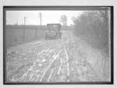 [auto driving on muddy country road "Premier"]