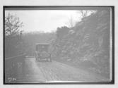 [auto driving on country road by rocks "Premier"]