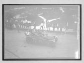 [auto tour in town with spectators & palm trees]
