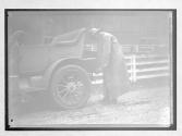 [auto racer in rain coat]