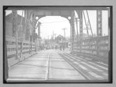 [auto races in village looking across bridge]