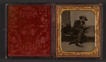 [Seated man reading]