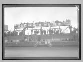 [Lozier #6 parked beneath mileage board]