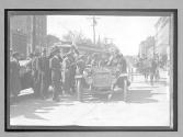 [auto tourist in town with spectators]
