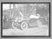 [auto tourist in town with spectators]