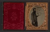 [Male teacher holding framed object]