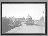["#63 Flanders" passing auto in ditch on road]