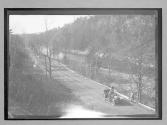 [auto parked on country road by river "NY38773"]