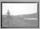 [auto driving on country road by railroad tracks "NY38773"]
