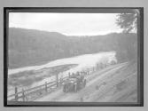 [auto driving on country road by river "NY38773"]