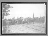 [two autos & ox with wagon on country road]