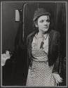 [Woman clutching doorway with frightened expression.]