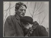 [Woman burying head in a man's chest on the cemetery set of the film "Native Land."]